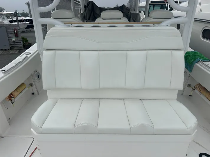 Fly Girl Yacht Photos Pics White seating on 2020 Invincible 39 Open Fisherman boat, featuring cushioned backrest and armrests.