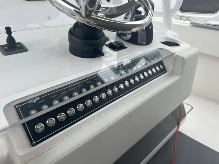 Fly Girl Yacht Photos Pics Control panel of a 2020 Invincible 39 Open Fisherman boat with steering wheel.