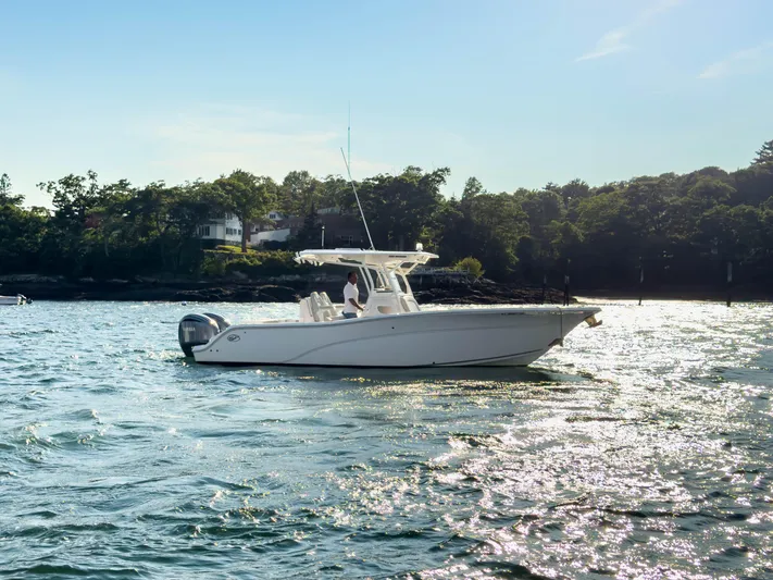 Lil Oa Yacht Photos Pics 2022 Sea Fox 288 Commander boat on water, with scenic shoreline background.
