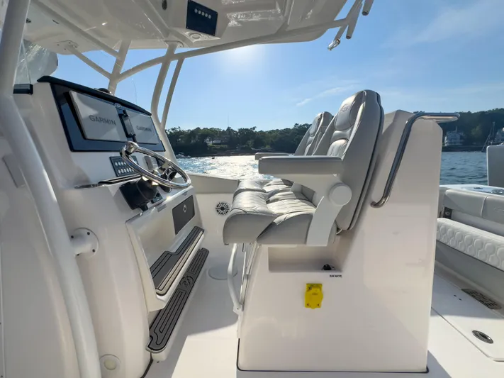 Lil Oa Yacht Photos Pics 2022 Sea Fox 288 Commander boat interior with steering wheel and cushioned seats.