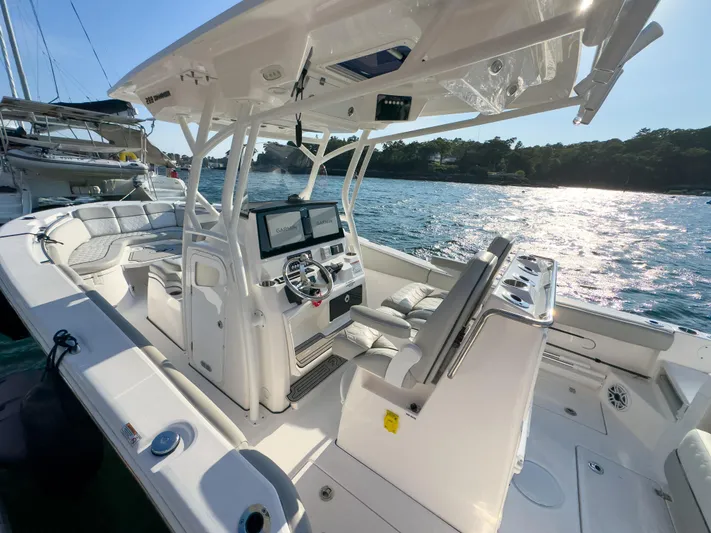 Lil Oa Yacht Photos Pics 2022 Sea Fox 288 Commander boat interior with modern helm and seating, docked by the water.