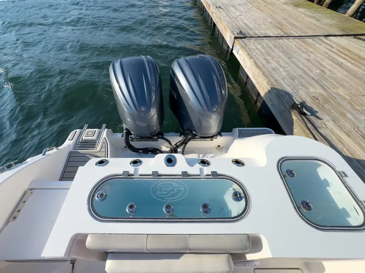 Lil Oa Yacht Photos Pics 2022 Sea Fox 288 Commander boat with dual outboard engines docked by the water.