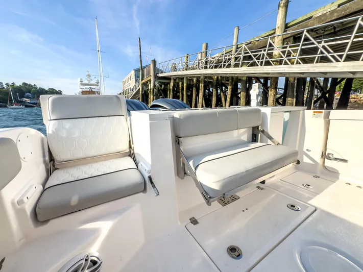 Lil Oa Yacht Photos Pics 2022 Sea Fox 288 Commander boat interior with comfortable seating near a dock.
