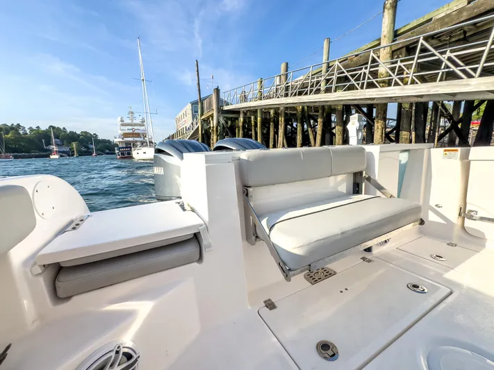 Lil Oa Yacht Photos Pics 2022 Sea Fox 288 Commander boat interior with seating, docked near a wooden pier.
