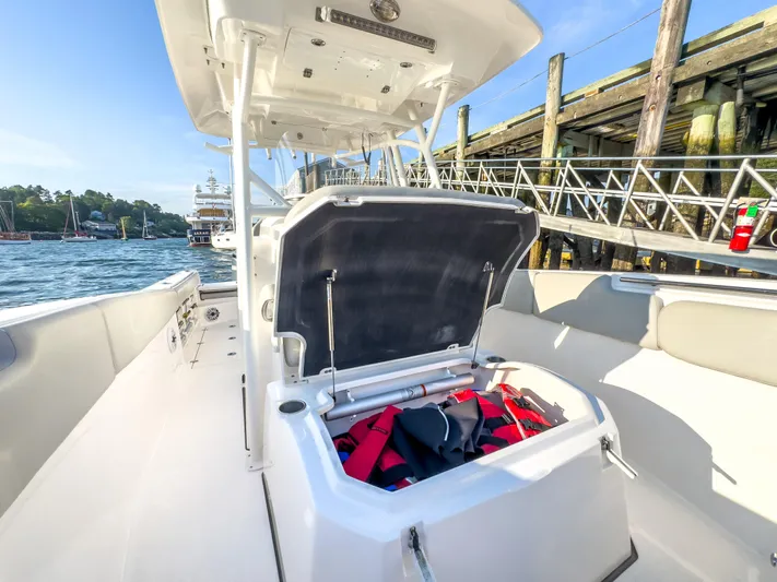 Lil Oa Yacht Photos Pics 2022 Sea Fox 288 Commander boat with open storage compartment, dockside view.