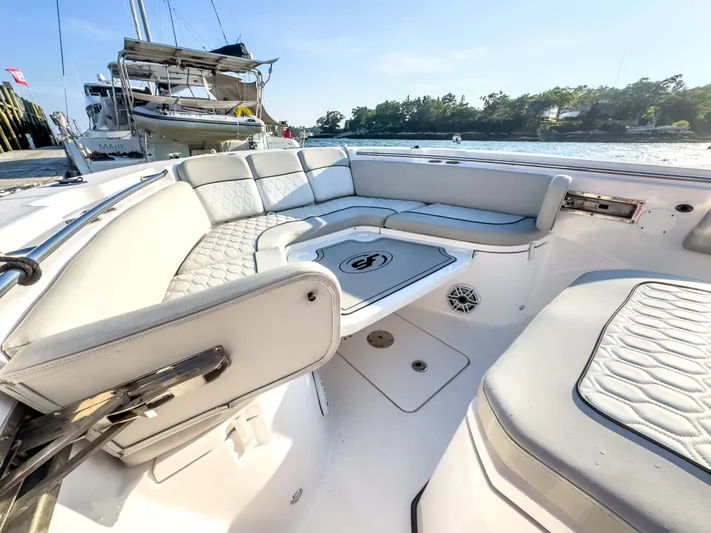 Lil Oa Yacht Photos Pics Luxurious seating area on a 2022 Sea Fox 288 Commander boat, docked by the water.