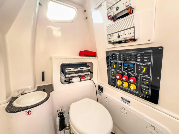 Lil Oa Yacht Photos Pics 2022 Sea Fox 288 Commander boat interior with control panel and compact bathroom.
