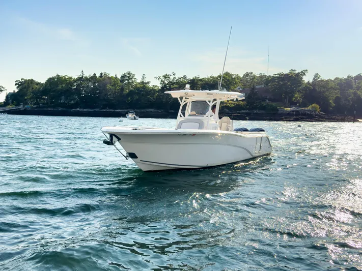 Lil Oa Yacht Photos Pics 2022 Sea Fox 288 Commander boat on water, with scenic shoreline background.