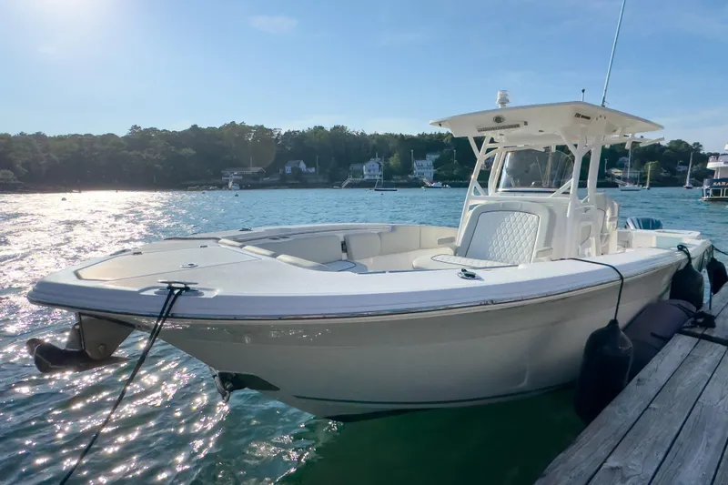 Lil Oa Yacht Photos Pics 2022 Sea Fox 288 Commander boat docked on a sunny day, with scenic waterfront background.