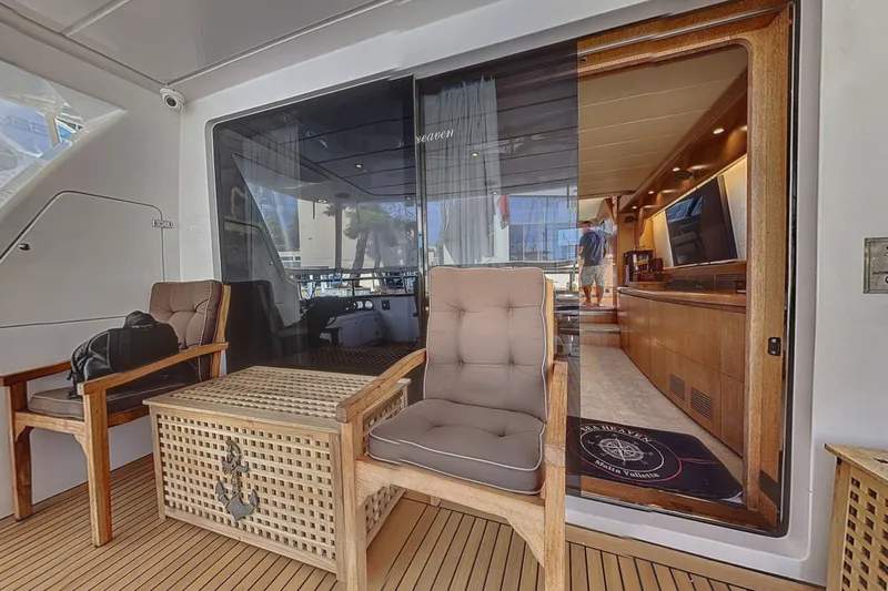  Yacht Photos Pics Luxurious 2002 Maiora 20 yacht interior with elegant seating and wooden accents.