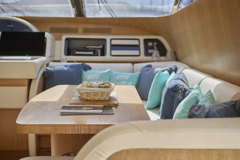  Yacht Photos Pics Luxurious interior of 2002 Maiora 20 yacht with elegant seating and decorative cushions.