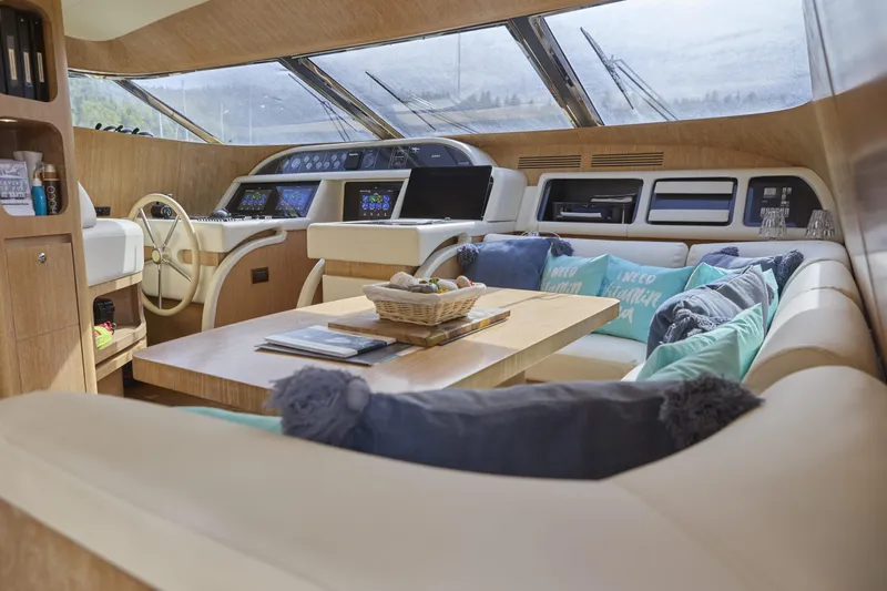  Yacht Photos Pics Luxurious interior of a 2002 Maiora 20 yacht with plush seating and modern controls.