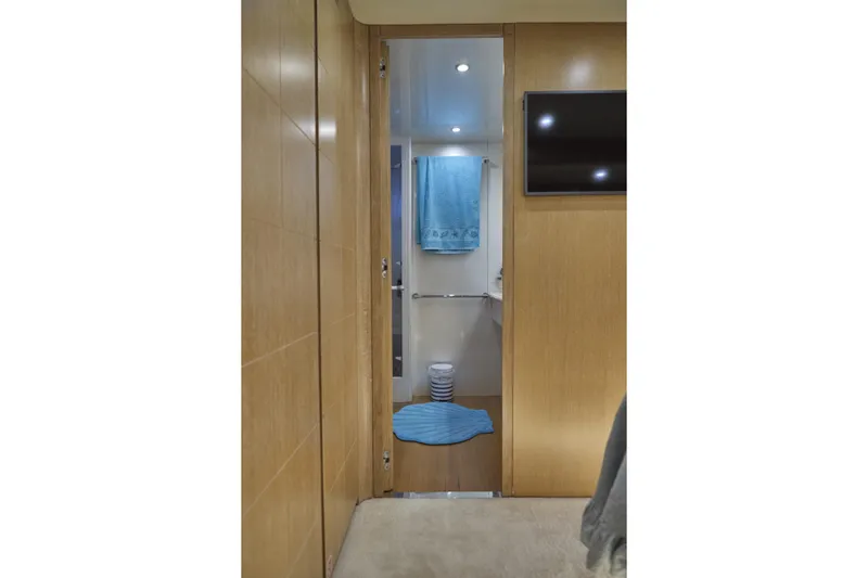  Yacht Photos Pics Interior of 2002 Maiora 20 yacht, featuring a modern bathroom with blue accents.