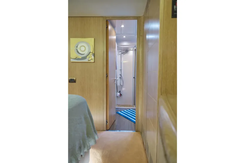  Yacht Photos Pics Interior view of a 2002 Maiora 20 yacht, featuring a cozy bedroom and bathroom.