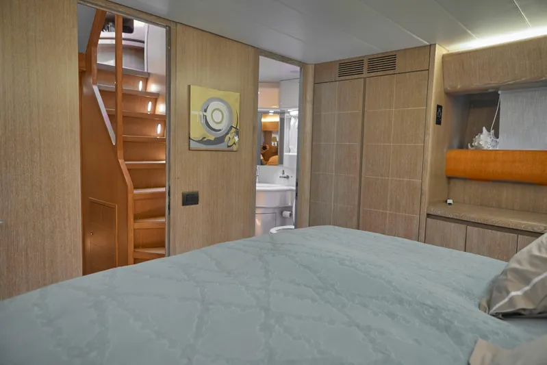  Yacht Photos Pics Luxurious Maiora 20 yacht interior, featuring a cozy bedroom and elegant wooden staircase, 2002 model.