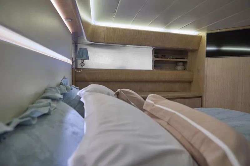  Yacht Photos Pics Luxurious Maiora 20 yacht bedroom interior, featuring elegant bedding and modern lighting, 2002 model.