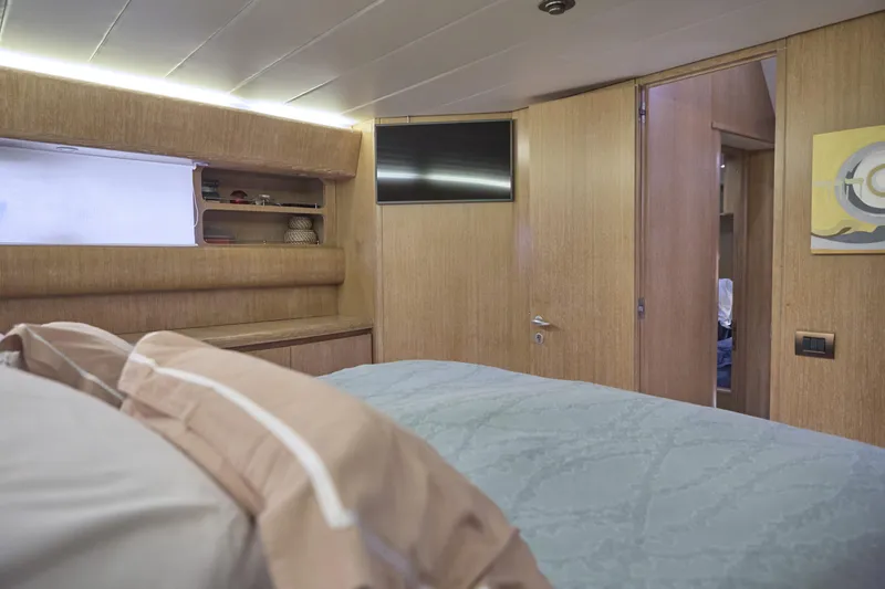  Yacht Photos Pics Luxurious cabin interior of 2002 Maiora 20 yacht with modern wood paneling.