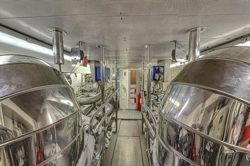  Yacht Photos Pics Engine room of a 2002 Maiora 20 yacht with polished metal surfaces and machinery.