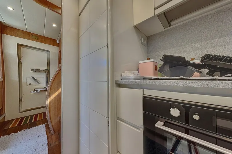  Yacht Photos Pics Interior of 2002 Maiora 20 yacht, featuring modern kitchen and sleek cabinetry.