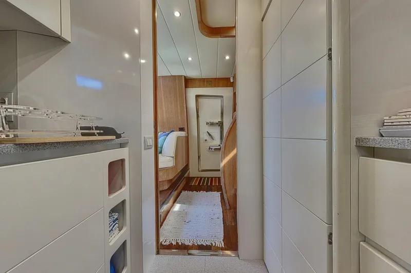  Yacht Photos Pics Luxurious interior of 2002 Maiora 20 yacht, featuring modern design and elegant wood finishes.