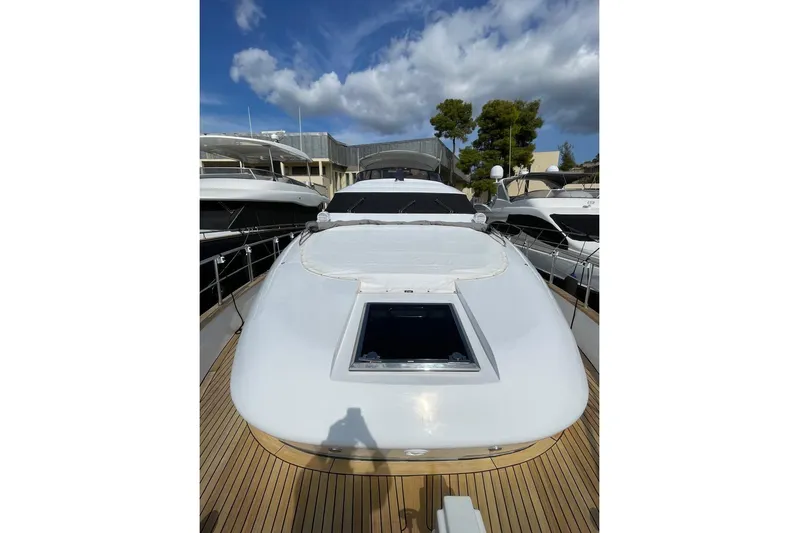  Yacht Photos Pics Luxurious 2002 Maiora 20 yacht docked under a partly cloudy sky.