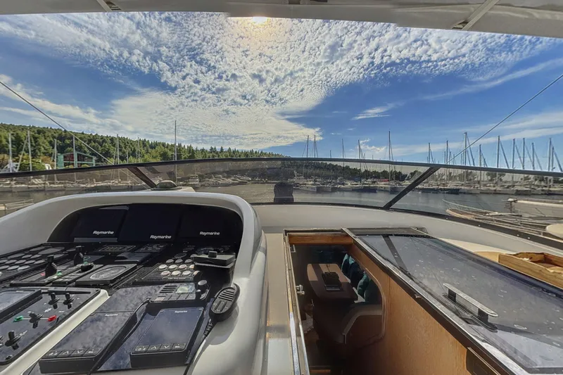  Yacht Photos Pics Cockpit view of 2002 Maiora 20 yacht with marina and sky backdrop.