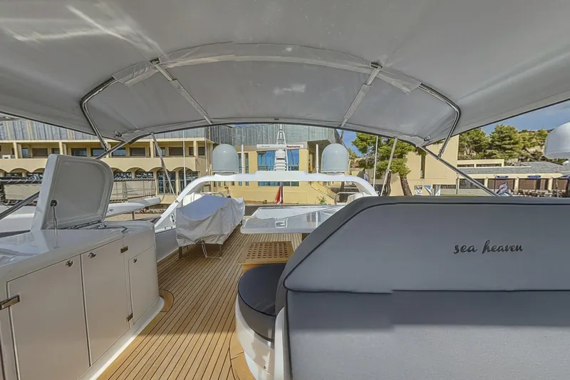  Yacht Photos Pics Luxurious 2002 Maiora 20 yacht deck with seating and covered area.