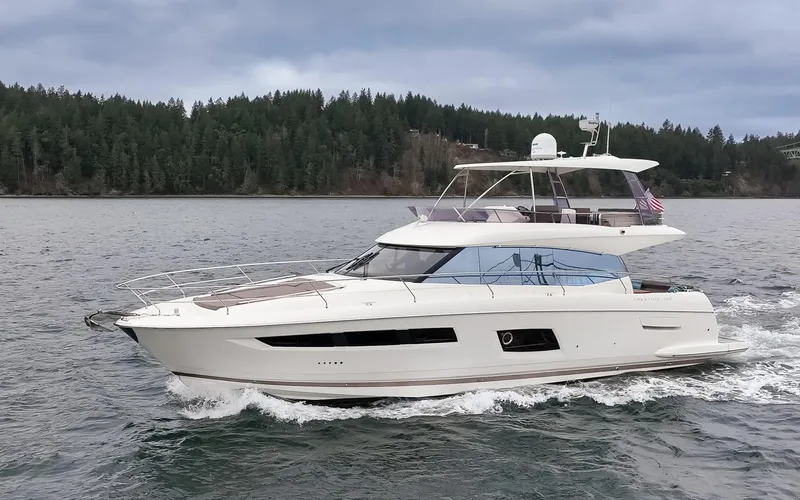 Little Nellie Yacht Photos Pics 2017 Prestige 560 yacht cruising on a scenic lake with forested shoreline.