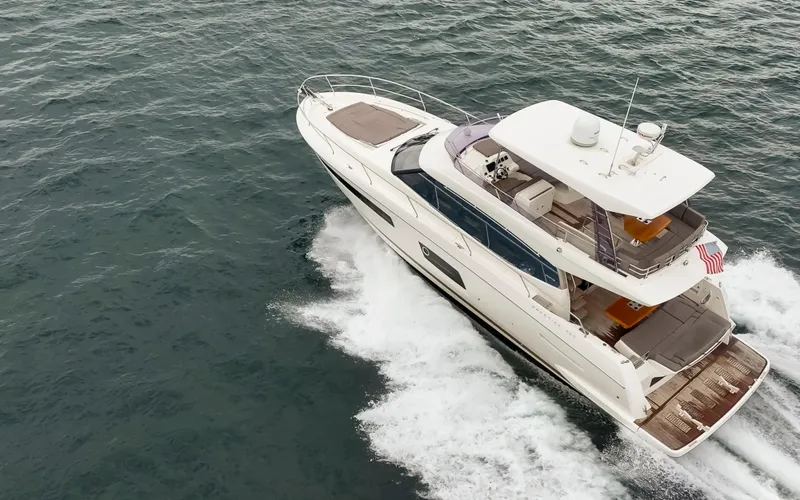 Little Nellie Yacht Photos Pics 2017 Prestige 560 yacht cruising on open water, aerial view.