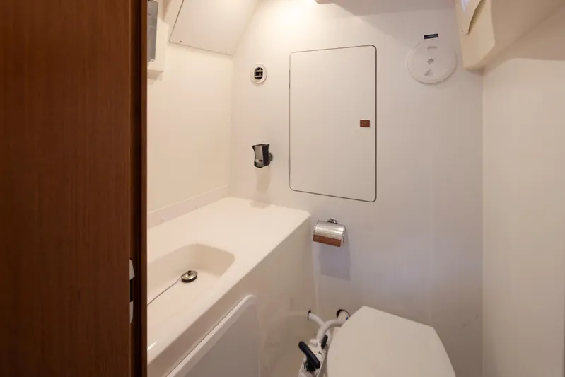 Little Nellie Yacht Photos Pics Compact bathroom in a 2017 Prestige 560 yacht, featuring modern fixtures and white interior.