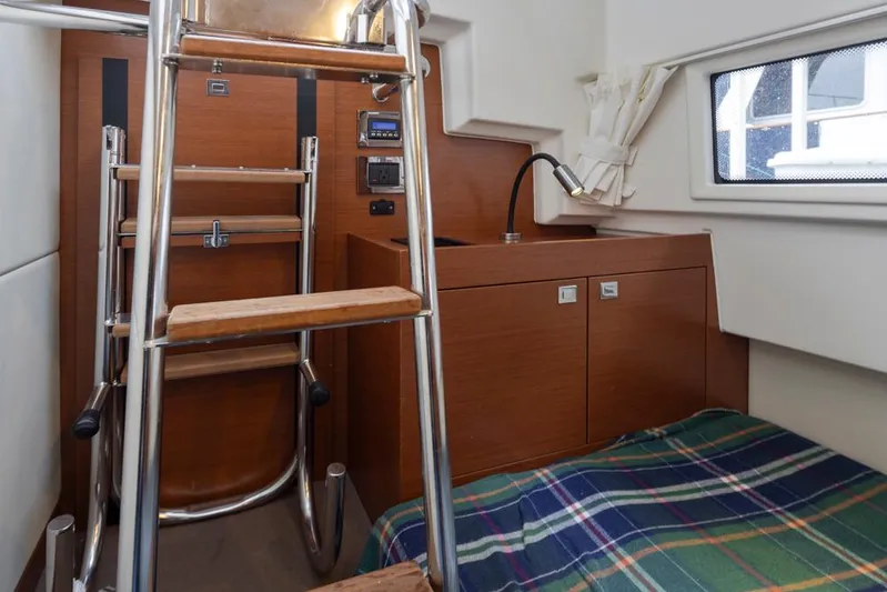 Little Nellie Yacht Photos Pics Interior of 2017 Prestige 560 yacht with wooden ladder and compact cabin space.