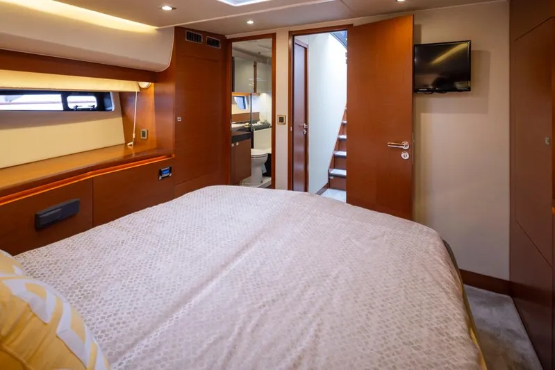 Little Nellie Yacht Photos Pics Luxurious bedroom interior of 2017 Prestige 560 yacht with modern amenities and elegant design.