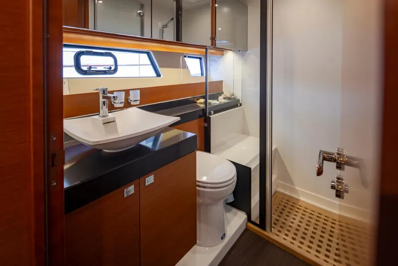 Little Nellie Yacht Photos Pics Luxurious bathroom in 2017 Prestige 560 yacht with modern fixtures and wooden accents.
