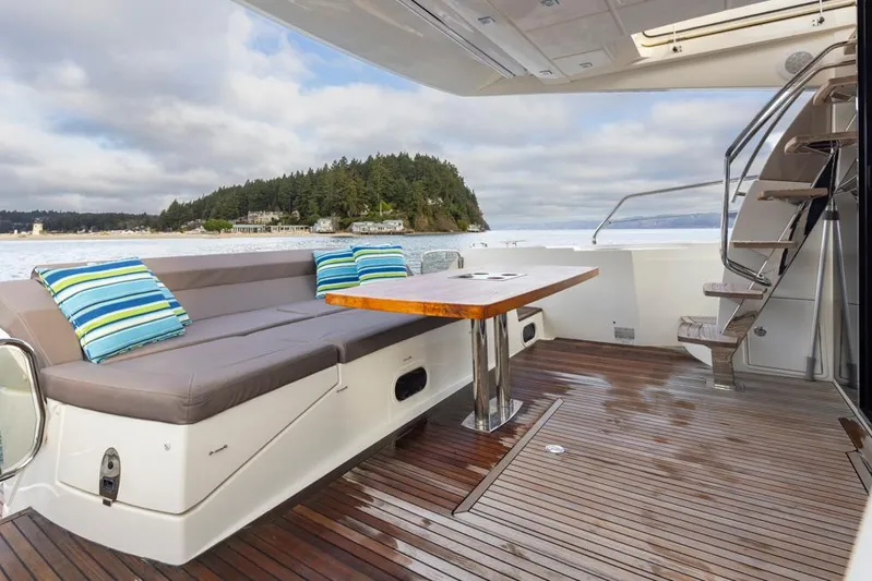Little Nellie Yacht Photos Pics 2017 Prestige 560 yacht deck with seating, table, and ocean view.