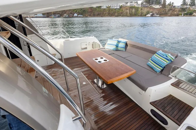 Little Nellie Yacht Photos Pics Prestige 560 yacht deck with seating and table, 2017 model, on calm water.