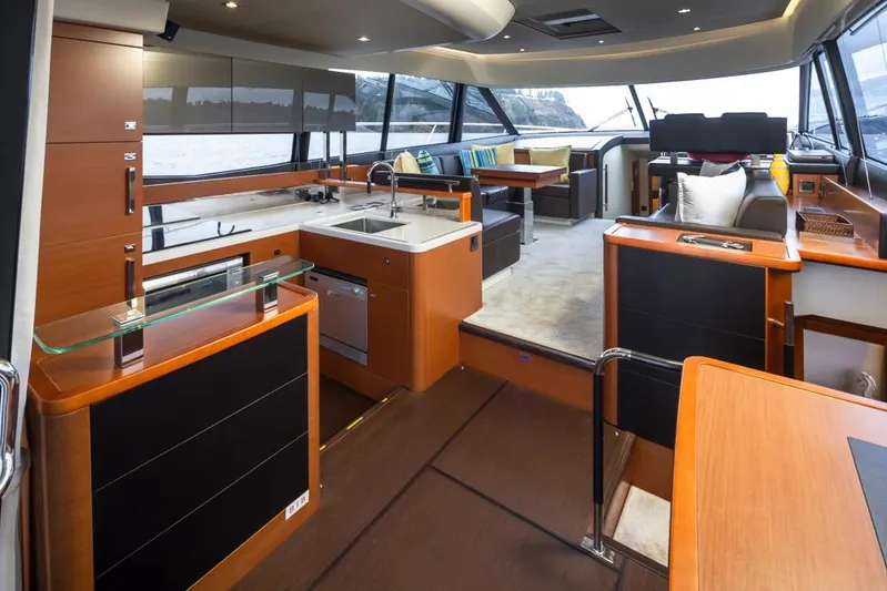 Little Nellie Yacht Photos Pics Luxurious interior of a 2017 Prestige 560 yacht with modern kitchen and seating area.