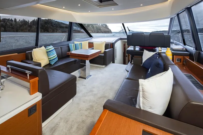 Little Nellie Yacht Photos Pics Luxurious interior of a 2017 Prestige 560 yacht with plush seating and scenic views.