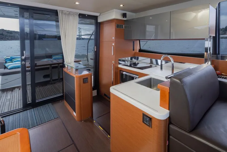 Little Nellie Yacht Photos Pics Interior of 2017 Prestige 560 yacht with modern kitchen and scenic water view.