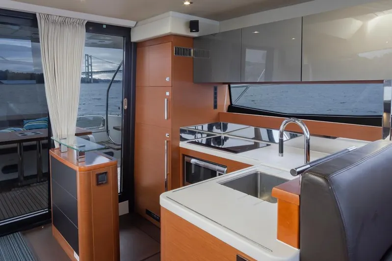 Little Nellie Yacht Photos Pics Interior of 2017 Prestige 560 yacht with modern kitchen and sleek design.