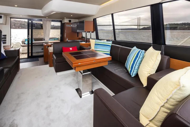Little Nellie Yacht Photos Pics Luxurious interior of 2017 Prestige 560 yacht with elegant seating and scenic water views.