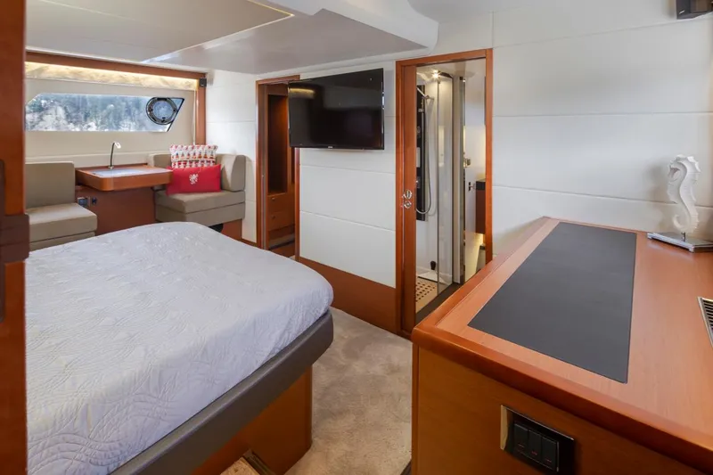 Little Nellie Yacht Photos Pics Luxurious interior of a 2017 Prestige 560 yacht with modern furnishings and a cozy bedroom.