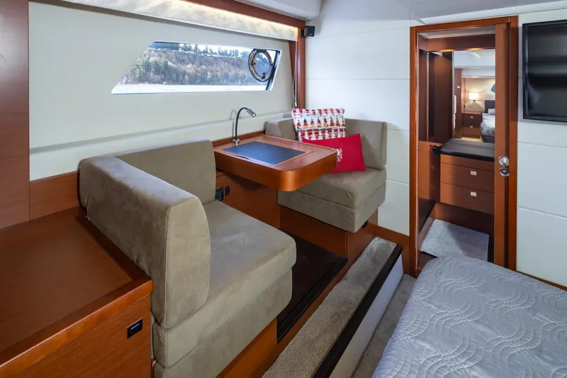 Little Nellie Yacht Photos Pics Luxurious interior of a 2017 Prestige 560 yacht with cozy seating and elegant decor.
