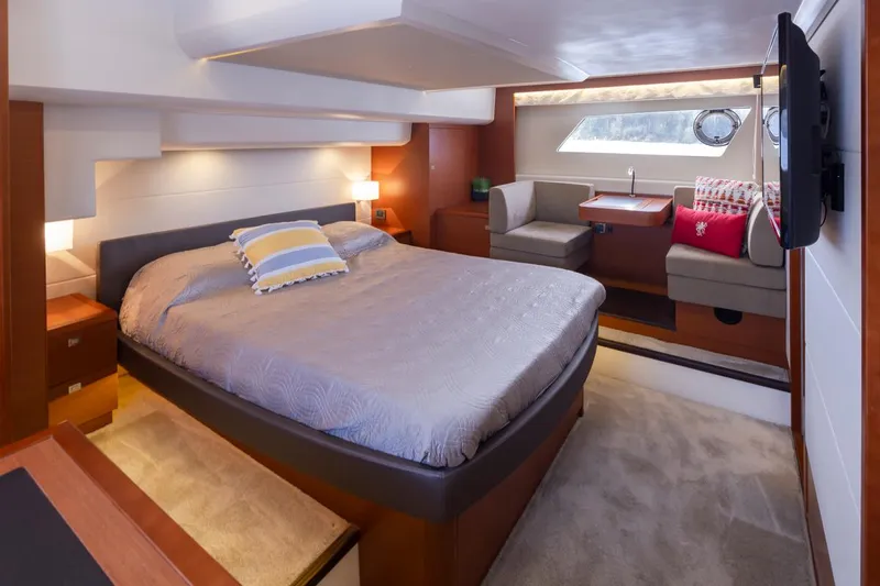 Little Nellie Yacht Photos Pics Luxurious bedroom interior of 2017 Prestige 560 yacht with cozy bed and seating area.