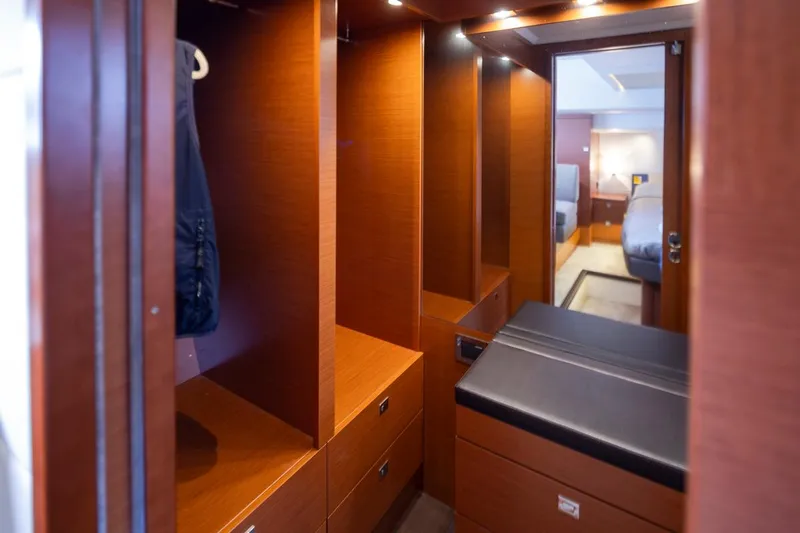 Little Nellie Yacht Photos Pics Luxurious wooden interior of 2017 Prestige 560 yacht, featuring spacious storage and elegant design.