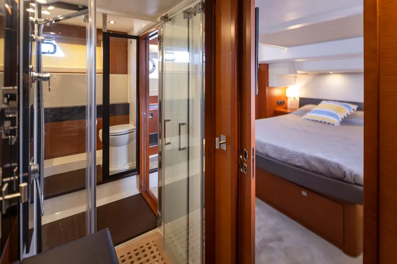 Little Nellie Yacht Photos Pics Luxurious interior of 2017 Prestige 560 yacht featuring bedroom and bathroom.