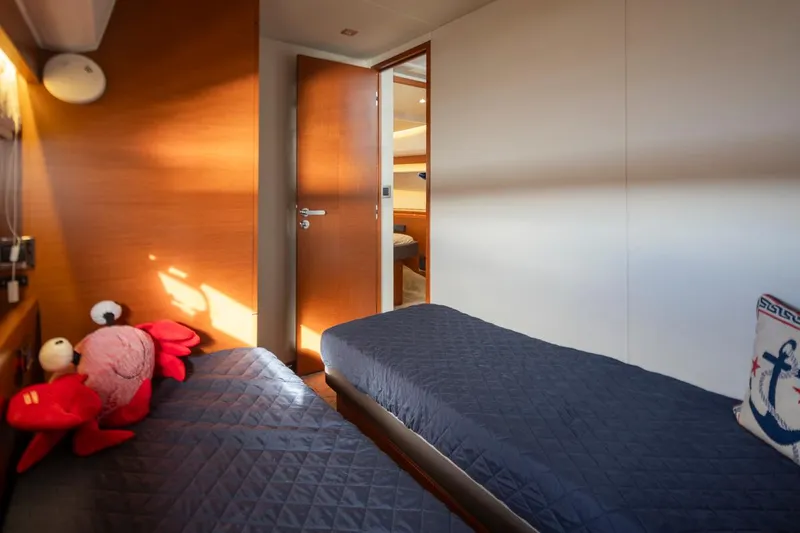 Little Nellie Yacht Photos Pics Twin cabin interior of 2017 Prestige 560 yacht with plush bedding and nautical decor.