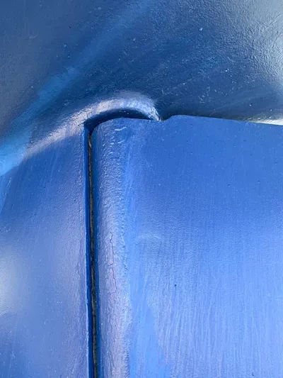  Yacht Photos Pics Close-up of blue hull detail on 2006 Hallberg-Rassy 48 MK sailboat.