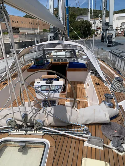  Yacht Photos Pics 2006 Hallberg-Rassy 48 MK sailboat with wooden deck and dual steering wheels in a marina.