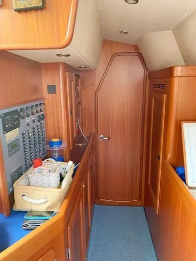  Yacht Photos Pics Interior of 2006 Hallberg-Rassy 48 MK sailboat with wooden cabinetry and control panel.