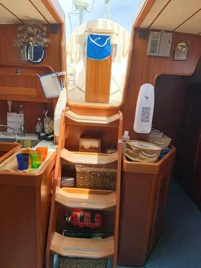  Yacht Photos Pics Interior of 2006 Hallberg-Rassy 48 MK sailboat with wooden stairs and nautical decor.